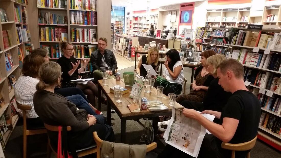 Michelle is at Foyles in Bristol, seated at a large table while tutoring the Picture Book Club South West. 